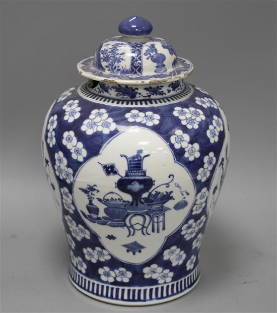 A 19th century Chinese blue and white jar, with panelled decoration, height 28cm and an associated vase lid